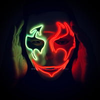A man wearing light up masquerade mask