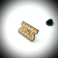 A pin of a ticket of 1 smile