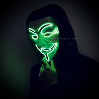 A man wearing light up guy fawkes mask